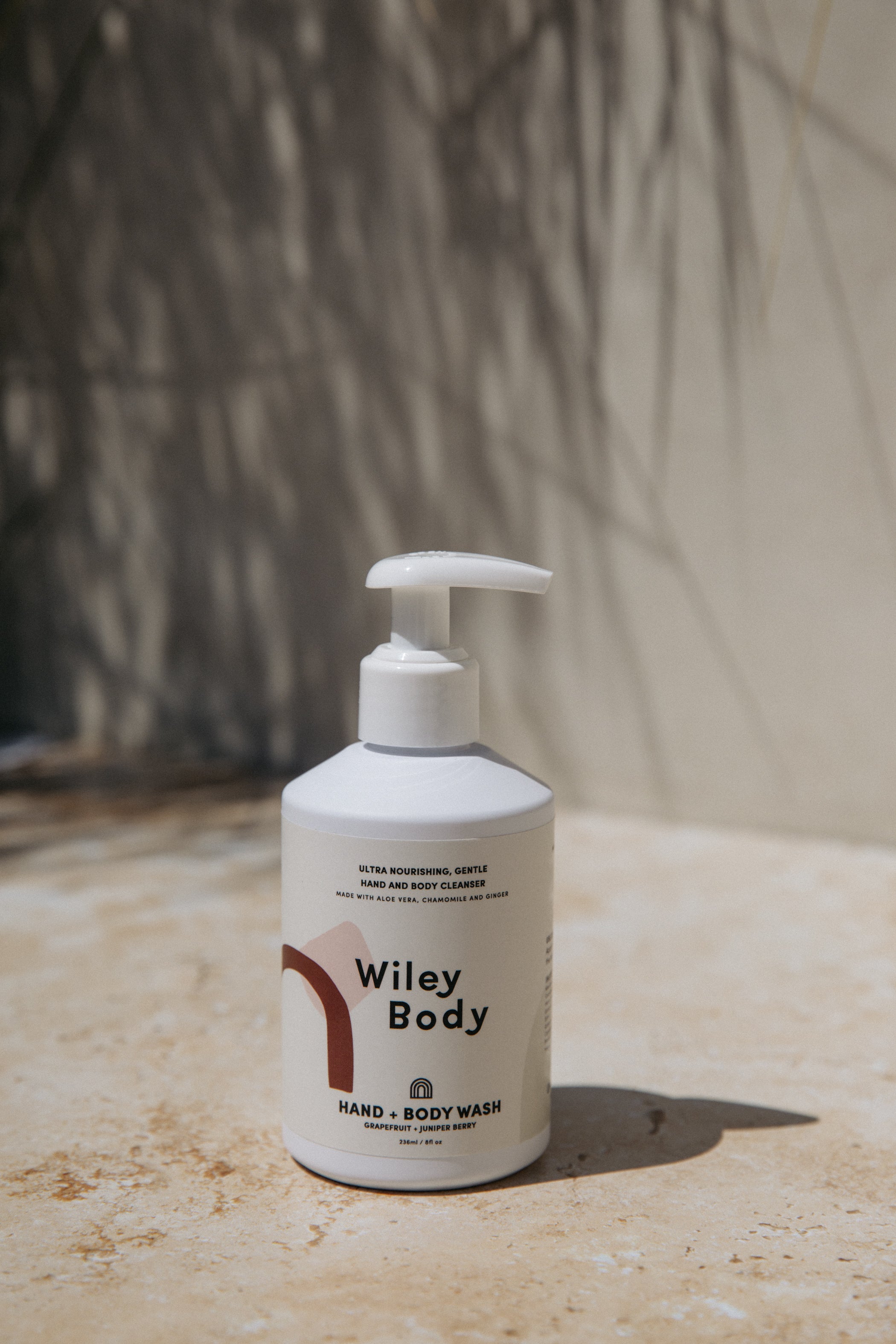 A white bottle with a label that reads Hand & Body Wash, ultra nourishing, gentle hand & body cleanser